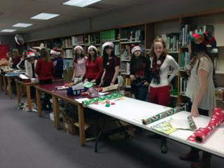 Volunteers in Paupack club members from Wallenpaupack Area High School wrap gifts for Santa's Elves Shopping Day.